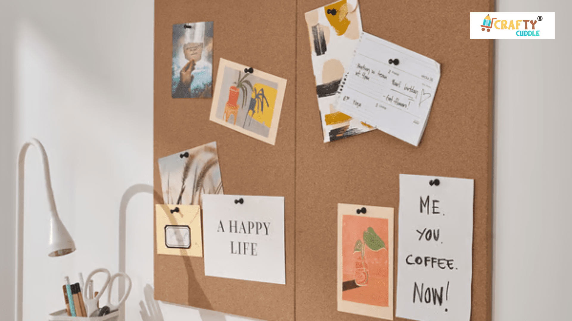 Image of memo board with papers on it and a lamp and pen stand placed on the table.