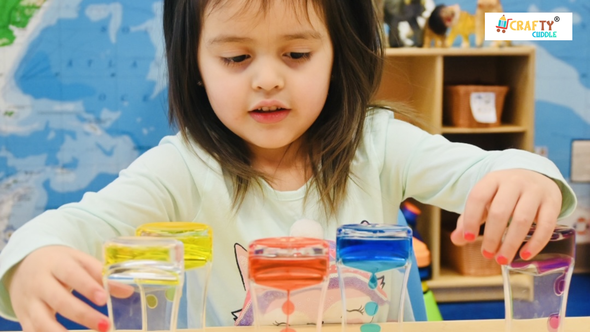 Image of a small girl perform mental activity by colorful glass of water.