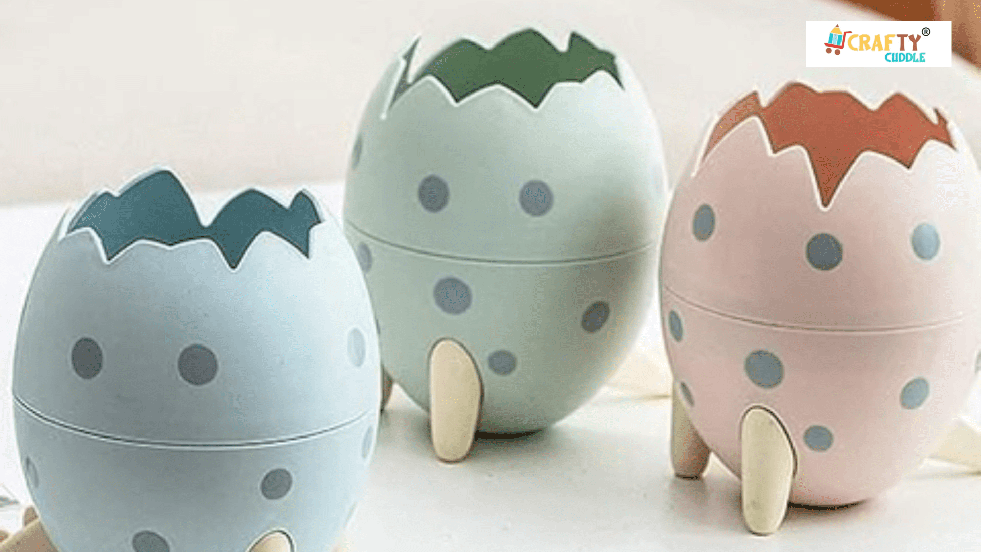 Image of three different colored Dino egg pen stand placed on the desk.