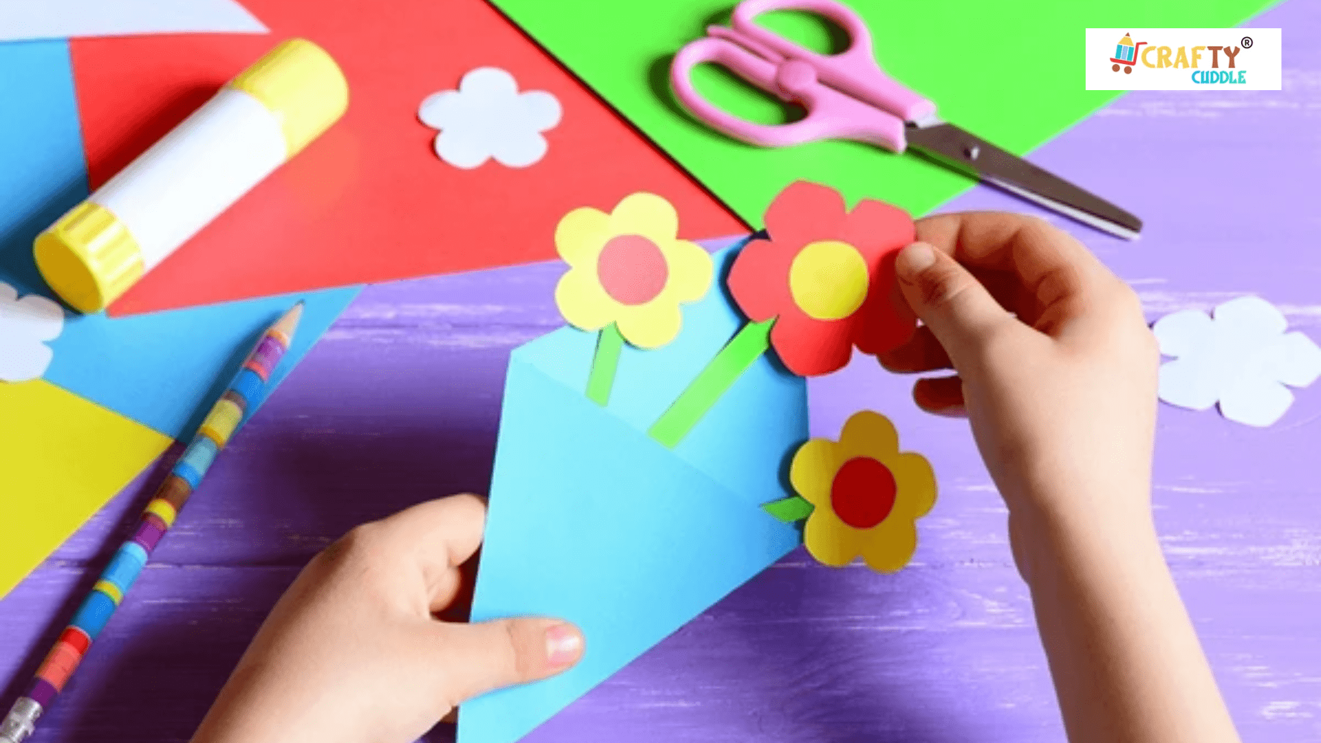 A child creating colorful paper flowers using glue, colored paper, and a rainbow-striped pencil on a purple table, showcasing fun and creative stationery supplies.