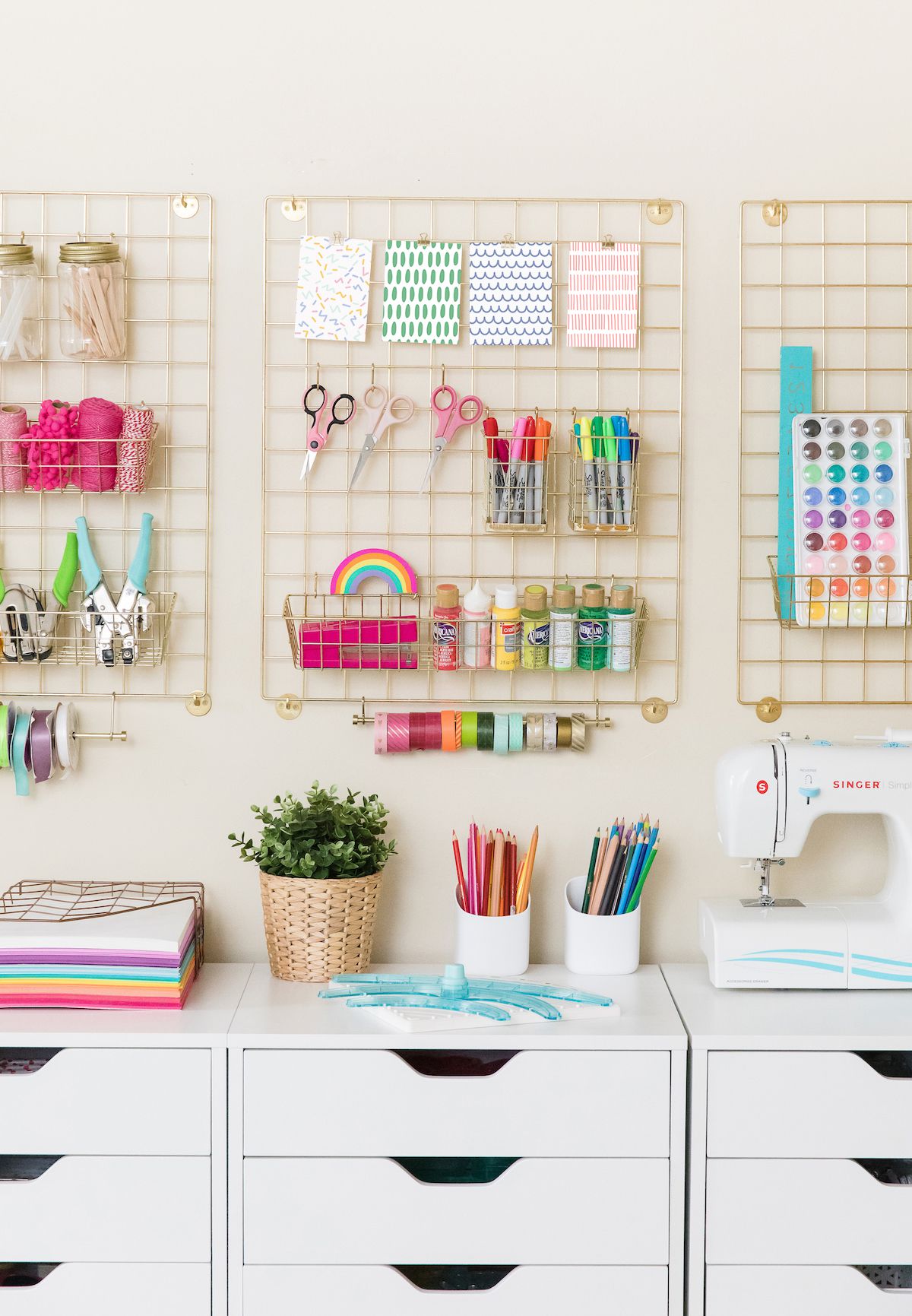 A room corner decorated with the crafts items such as washi tapes, scissors and colorful pages.