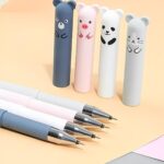 Set of pens with cartoon animal ends on a light background