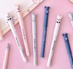 Set of pens with bear-shaped ends on a pink background