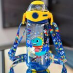 650 ml VEST kids water bottle with space and dinosaur print, spill-proof sipper lid, and carry strap.