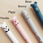 Erasable Gel Pens – 4 Cute Animal DesignsErasable Gel PensCRAFTY CUDDLESet of cartoon - themed pens on a wooden surfacePiggy🐷1animalpenserasablepens