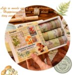 Set of washi tape rolls with decorative packaging held by a hand, surrounded by nature-themed elements.