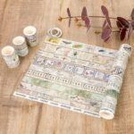 Washi Tape Box of 20 – Jungle Traces SeriesCRAFTY CUDDLESet of washi tape rolls with nature - themed designs on a wooden surface.