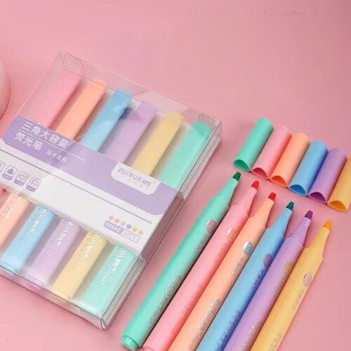 Set of colorful highlighters with packaging on a pink background