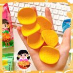 Hand holding yellow chips eraser with cartoon character packaging in the background