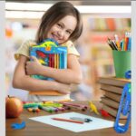 Child holding a book with colorful crayons, surrounded by stationery items on a desk.