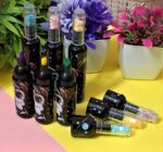 Galaxy HighlightersCRAFTY CUDDLESet of small bottles with colorful caps on a yellow surface with flowers in the backgroundBottle Highlighters