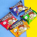 Four packages of instant noodle erasers with cartoon characters on a blue and yellow background