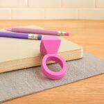 Pink desk organizer with two pencils on a notebook
