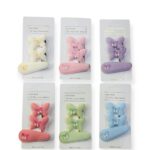 Set of six colorful hair clips in packaging on a white background