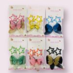 Set of colorful butterfly and star-shaped hair accessories on hand-made cards.