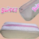 This is the image of a pencil pouch of grey color with a sweet band.