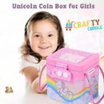 girl smiling and holding a colorful unicorn-themed piggy bank, promoting the concept of saving money in a fun and engaging way.