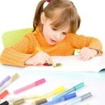 Girl writing with a 2mm medium tip vibrant acrylic marker on paper