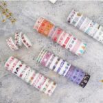 Set of colorful washi tape rolls on a textured surface