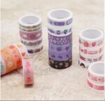 Set of colorful washi tape rolls on a light background