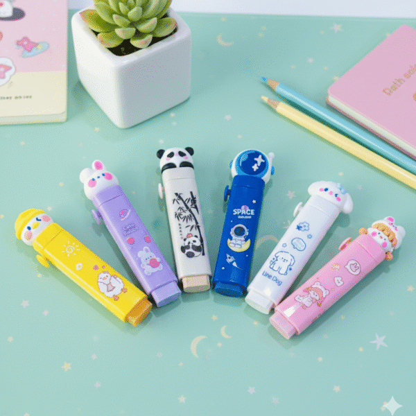 Set of colorful erasers on a light green surface with a small plant and pencils.