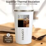 White insulated coffee cup with 'COFFEE' text on a wooden surface, featuring double-wall vacuum insulation technology.