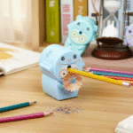Cute Pastel Pencil Sharpener for KidsStationery > Erasers & SharpenersCRAFTY CUDDLECute blue pencil sharpener with cartoon face on a desk with colorful pencilsSky Blue