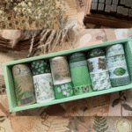 Set of washi tape rolls in a green box on a vintage paper background