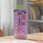 Pink cartoon character pencil sharpener on a light beige surface with a light gray background