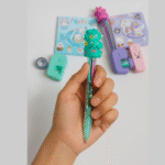 Cute Cat Kids Stationery Gift SetStationery SetsCRAFTY CUDDLEHand holding a green pen with a cat design, surrounded by stationery items on a light gray background.Pack of 2 (Purple & Green)kidsstationery cutestationery schoolsupplies backtoschool stationerylove cartoonstationery kawaiistationery kidsgifts returngifts studentessentials stationeryshop creativekids schoolessentials giftideasforkids trendingproducts shopnow