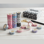 Washi Tape - 18 Rolls MulticolorDecorative Washi TapeCRAFTY CUDDLEAssorted washi tape rolls on a wooden surface with a pen and scissors.washitape washitapelove washitapeaddict floralstationery botanicalstationery naturestationery journaling junkjournal scrapbooking artjournaling creativejournaling aestheticstationery stationerylovers