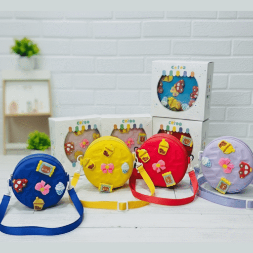 Colorful children's bags with decorative elements on a white surface.