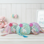 Unicorn Sling Bag with Rainbow StrapKids BagsCRAFTY CUDDLEThree colorful unicorn - themed sling bags on a light wooden surface with a white wooden panel background.GreenUnicornBag KidsSlingBag GirlsCrossbody CuteKidsAccessories UnicornTheme PastelFashion RainbowStrap BirthdayGiftForGirls ReturnGiftIdeas KidsFashion