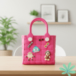 Pink children's handbag with cartoon characters on a wooden surface