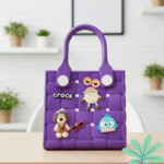 Waterproof EVA Handbag for GirlsKids BagsCRAFTY CUDDLEPurple children's handbag with cartoon character decorations on a wooden surface.PurpleKidsToteBag GirlsHandbag CuteKidsAccessories WaterproofBag CartoonBag MiniTote KidsFashion TrendyForKids GiftForGirls EverydayCarry