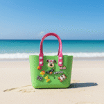 Cute Cartoon Charm Tote Bag for KidsKids BagsCRAFTY CUDDLEGreen children's bag with pink handles on a sandy beach with ocean in the backgroundGreenKidsToteBag BeachBag SummerAccessories CuteKidsStyle GirlsHandbag WaterproofBag CartoonBag TrendyKids VacationReady GiftForGirls