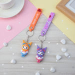 Kuromi Theme Keychain with StrapKeychainsCRAFTY CUDDLETwo cartoon character keychains on a wooden surface with decorative elements.1CuteKeychain GothicBunny KawaiiAccessories GirlsBagCharm CartoonKeyring ReturnGifts BackpackAccessory TrendyKeychains SiliconeKeychain GiftForGirls