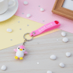 Two colorful keychains on a pastel background