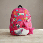 Kids Cartoon Backpack with Detachable Sling BagKids BagsCRAFTY CUDDLEPink children's backpack with shark design on a wooden surfaceSharkKidsBackpack CartoonSchoolBag NurseryBag PreschoolBackpack ToddlerSchoolBag SchoolBagForKids LightweightBackpack KidsTravelBag KindergartenBag BackpackWithSling