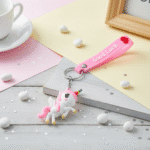 Unicorn Silicone KeychainKeychainsCRAFTY CUDDLEUnicorn keychain with 'Good Luck' tag on a decorative surface with a cup and frame.1UnicornKeychain CuteAccessories GirlsAccessories BagCharms UnicornLover ReturnGiftIdeas KidsFashion KawaiiStyle TrendyKeychains GiftForGirls