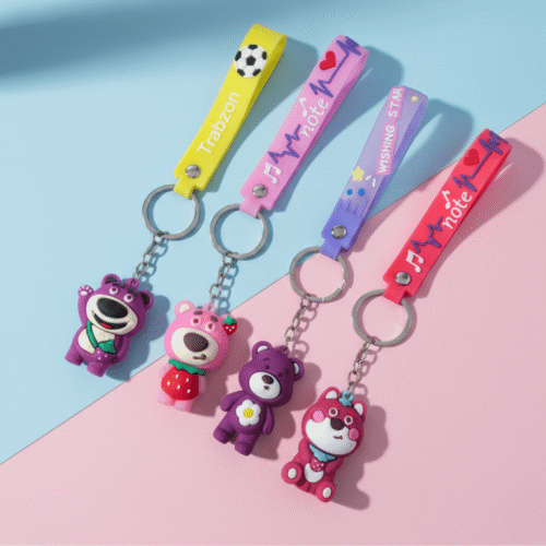 Colorful keychains with bear figures on a pink and blue background