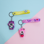 Cute Teddy Bear Silicone KeychainKeychainsCRAFTY CUDDLETwo keychains with cartoon bear designs on a pink and blue background1TeddyBearKeychain CuteKeychain CartoonKeyring KawaiiAccessories GirlsBagCharm BackpackCharm SiliconeKeychain ReturnGifts TrendyKeychains GiftForGirls