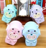 Four cute cartoon-style sharpeners on a wooden surface with books in the background.