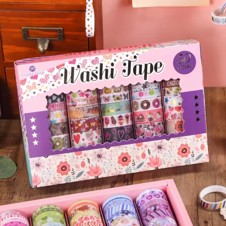 Box of washi tape with colorful designs on a wooden surface