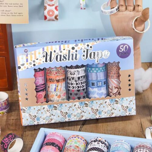 Box of washi tape with colorful designs on a wooden surface