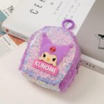 Mini Sequin Coin Pouch for KidsCoin pouchCRAFTY CUDDLESequined pouch with cartoon character and 'KUNOMI' branding on a surface with books in the backgroundPurpleSequinPouch CuteAccessories KidsAccessories CoinPouch GlitterPouch ReturnGiftIdeas KawaiiStyle MiniPouch StationeryLovers TrendyKids