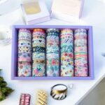 Star Pattern Washi Tape – 50 RollsDecorative Washi TapeCRAFTY CUDDLESet of colorful washi tapes in a purple box on a white surface with decorative items.washitape washitapelove washitapecollection papercrafts diycrafts journaling bulletjournal plannerdecor creativejournaling stationerylovers aestheticstationery