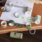 Green Botanical Washi Tape Set - 18 RollsDecorative Washi TapeCRAFTY CUDDLEGreen washi tape rolls on a cork board with a notebookwashitape washitapelove washitapeaddict botanicalstationery natureinspired greenaesthetic journaling junkjournal artjournaling scrapbooking creativejournaling aestheticstationery stationerylovers