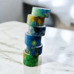 Ocean Blue Washi Tape Set - 18 RollsDecorative Washi TapeCRAFTY CUDDLEStack of colorful washi tape rolls on a marble surfacewashitape washitapelove washitapeaddict blueaesthetic oceaninspired abstractart journaling artjournaling junkjournal scrapbooking creativejournaling aestheticstationery stationerylovers