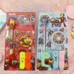 Superhero Kids Stationery Gift SetStationery SetsCRAFTY CUDDLETwo packages of stationery items with superhero designs on a pink textured background.Pack of 2 (Red & Sky Blue)BackToSchoolGearStationeryAddict